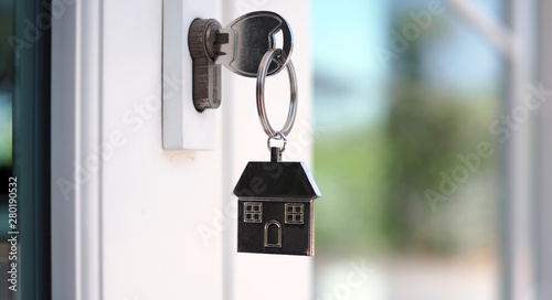 The house key for unlocking a new house is plugged into the door. © Shisu_ka