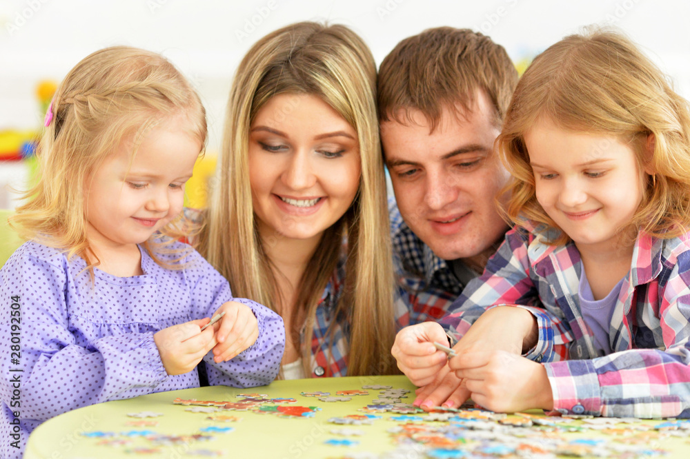 Portrait of parents and children collecting puzzle