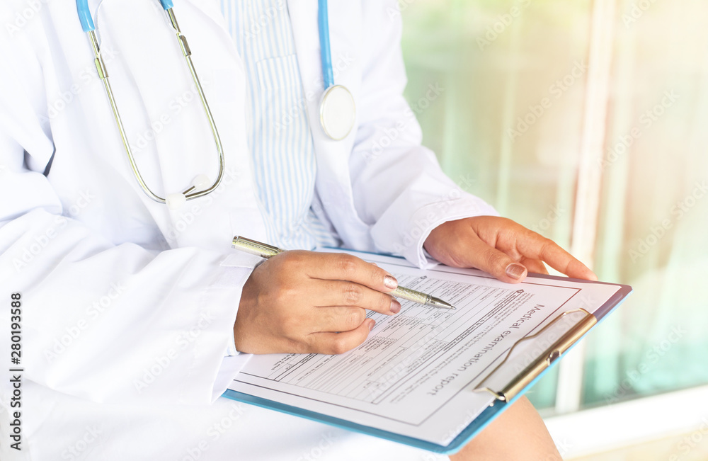 doctor woman asian note on medical record - medical examination report for diagnosis in the hospital - healthcare checks physician at work or nurse and patient are discussing about diagnosis