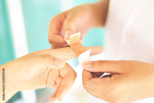 Finger wound bandaging an injured by nurse - first aid finger injury health care and medicine concept