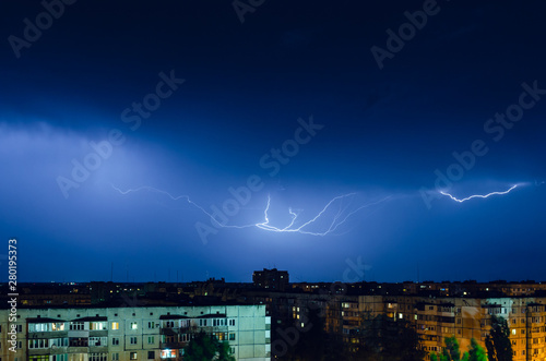 Thunderstorm with lightning and thunder over the night city