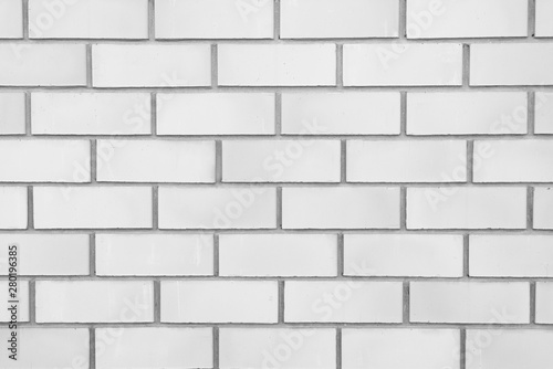 White classic brick wall close-up with stitching. The texture of the stone masonry. Brick background for a subject shooting a flat lay. Concept of construction and interior design. Copy space