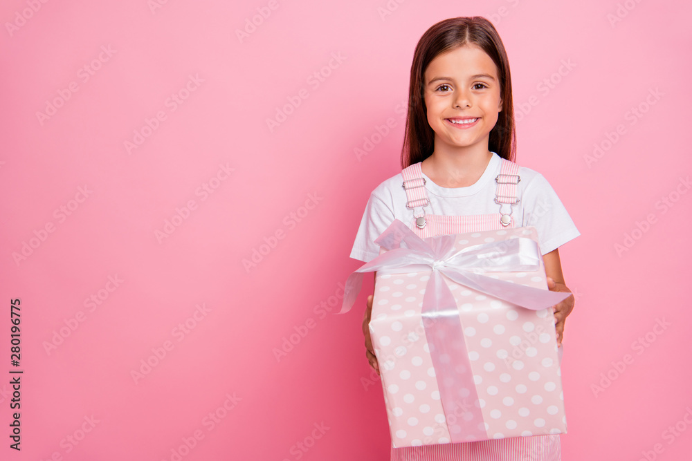 Closeup photo of little lady hands hold large giftbox christmas holidays weekend wear overall isolated pink background Closeup photo of little lady hands hold large giftbox christmas holidays weekend wear overall isolated pink background