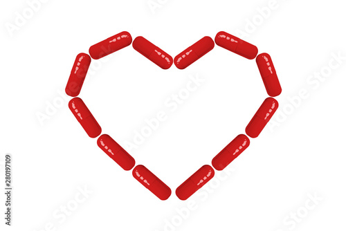 Heart shape made from red pills and capsules isolated on white background