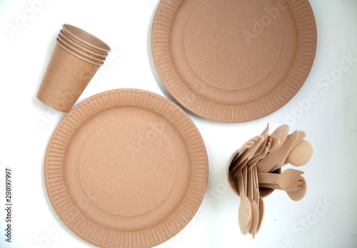 disposable natural eco dishes from paper cardboard forks spoons knives glasses tallets photo