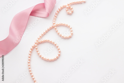 mockup with pearls and pink ribbon on white background