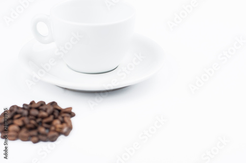 Coffee beans and cup isolated on white background.Copy space