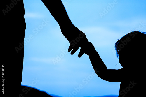 happy parent with child in nature by the sea silhouette