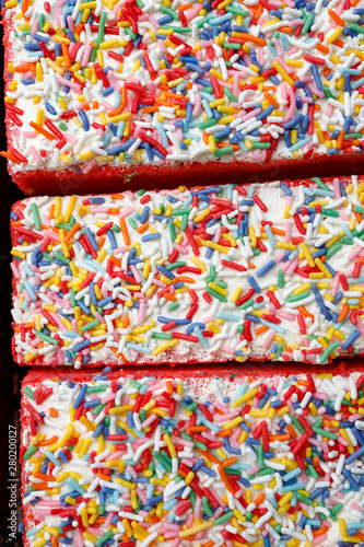 Colourful layer cake with sprinkles  at weekly street market
