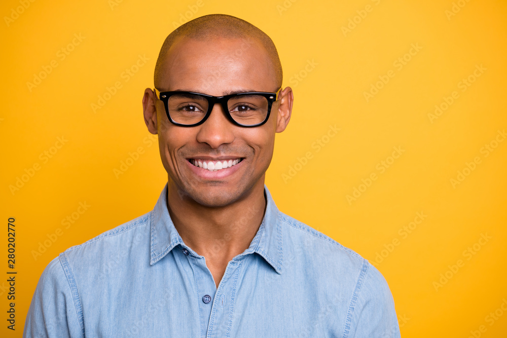 Photo of dark skin macho attractive appearance not smiling conference wear specs jeans denim shirt isolated bright yellow background - obrazy, fototapety, plakaty 