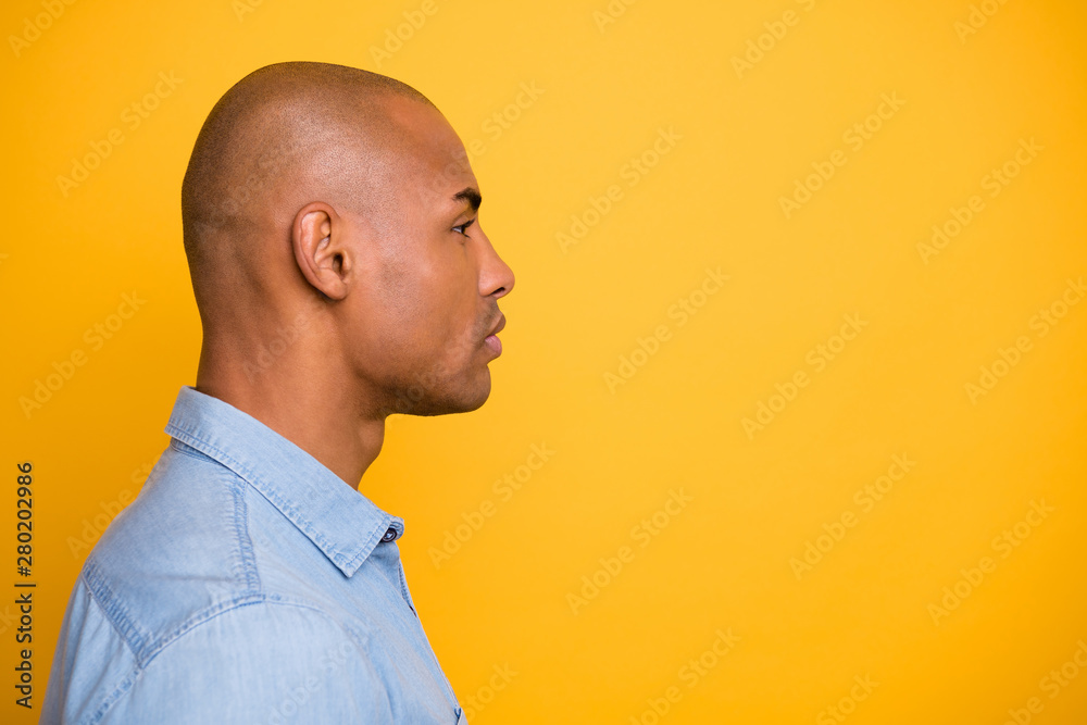 Profile photo of dark skin macho not smiling moody wear jeans denim shirt isolated bright yellow background Profile photo of dark skin macho not smiling moody wear jeans denim shirt isolated bright yellow background