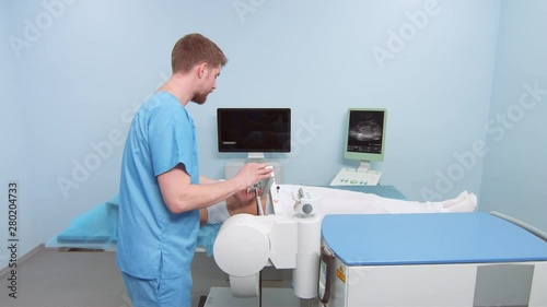 Doctor prepares patient for kidney stone shockwave lithotripsy photo