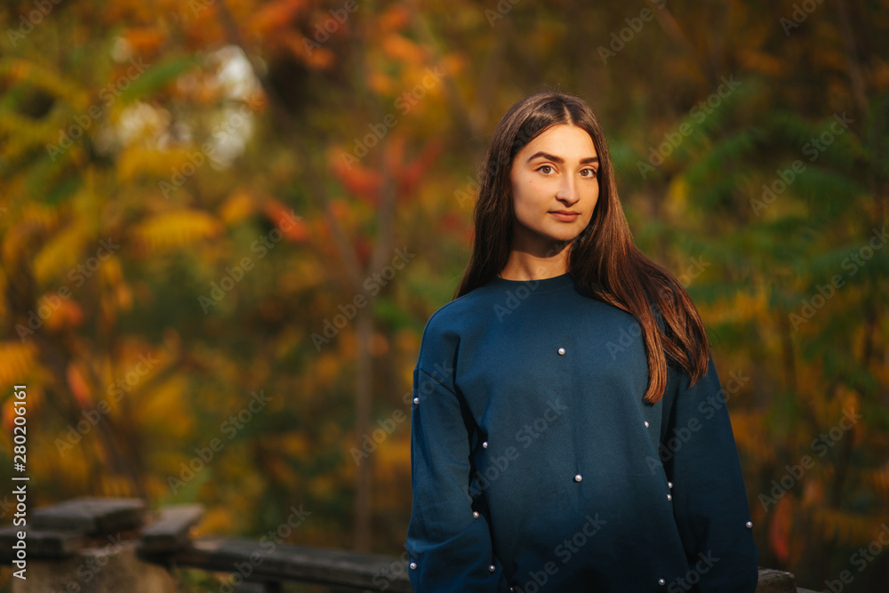 Beautiful female model walking in the forest in autumn weather Beautiful female model walking in the forest in autumn weather