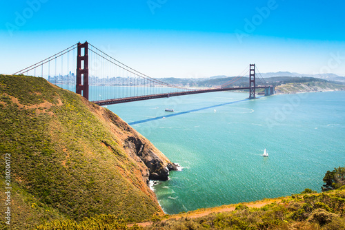 Golden Gate Bridge, California, U.S.A. Scenic city and landscape panorama over SF Bay waters, view from North Vista Point area,  with sailing boats and blue sky. Architectural icon of San Francisco