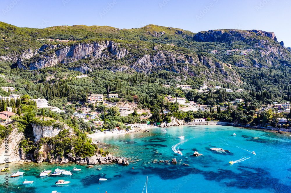 Fototapeta premium Aerial view of beautiful green and rocky island in the blue ocean.