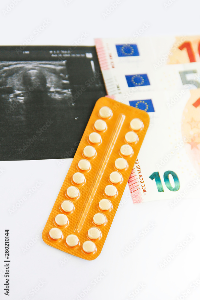 hormonal pills and euro money on the background of the sheet with ultrasound hormonal pills and euro money on the background of the sheet with ultrasound