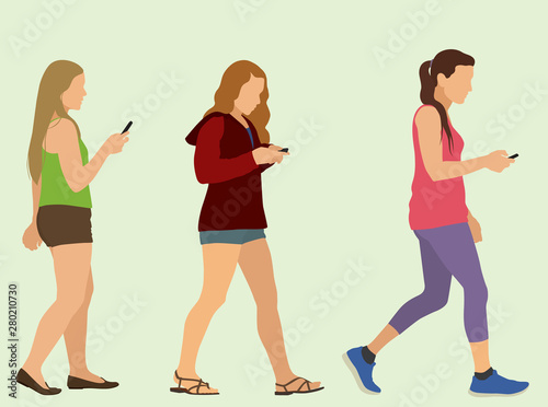 Young Women or Teenage Girls Walking While Texting