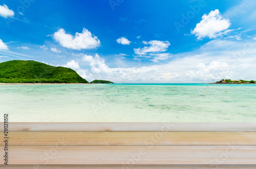Fototapeta Naklejka Na Ścianę i Meble -  wood table with tropical beach and sea summer and blue sky with cloud background. beautiful floor copy space for design your products brand for ad.