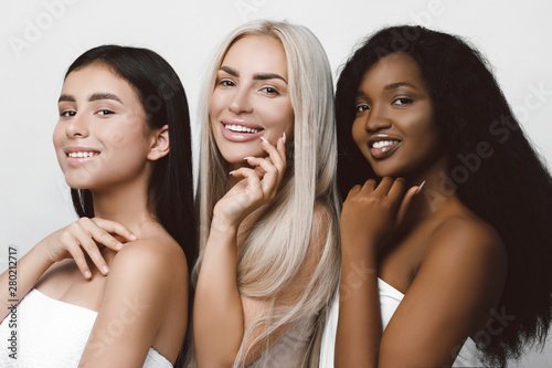 Three different nation girls with diversuty in skin, hair. Caucasian, African american and Asian girls cheerful emotional posing on white background, lifestyle people concept.