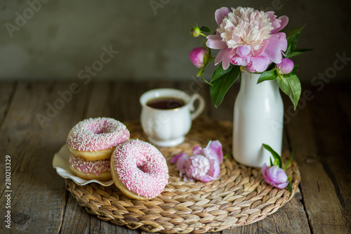 Donuts with fragrant tea. Bakery products. Peonies