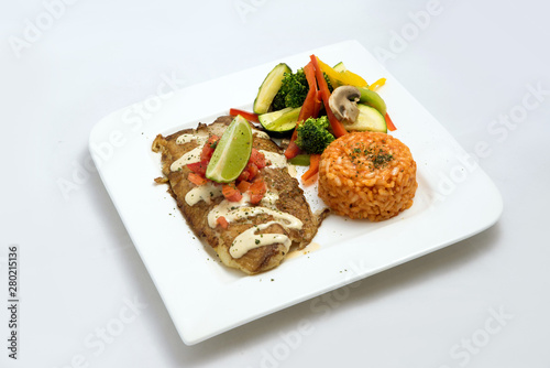 A Hero shot of a grilled fish fillet gratini with vegetables & lentils on the side, on a white plate, minimal background with a 60 degree front facing perspective.