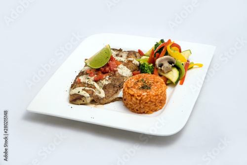 A Hero shot of a grilled fish fillet gratini with vegetables & lentils on the side, on a white plate, minimal background with a 60 degree front facing perspective.