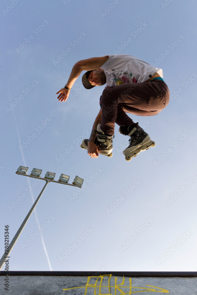 Man rollerblade doing tricks on ramps and handbars agressive Man rollerblade doing tricks on ramps and handbars agressive