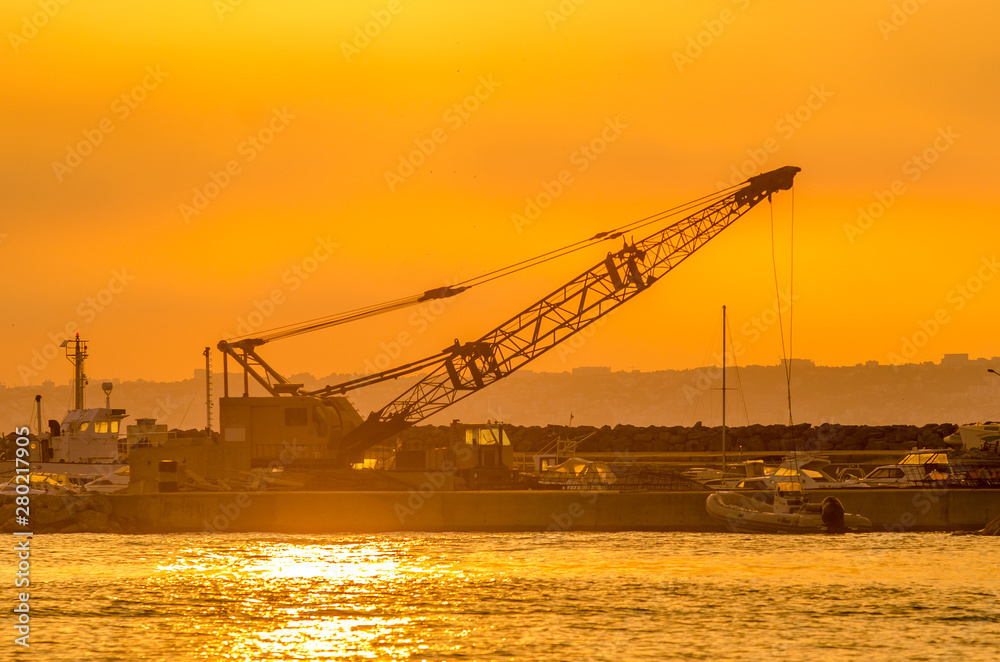 maritime crane in sunset
