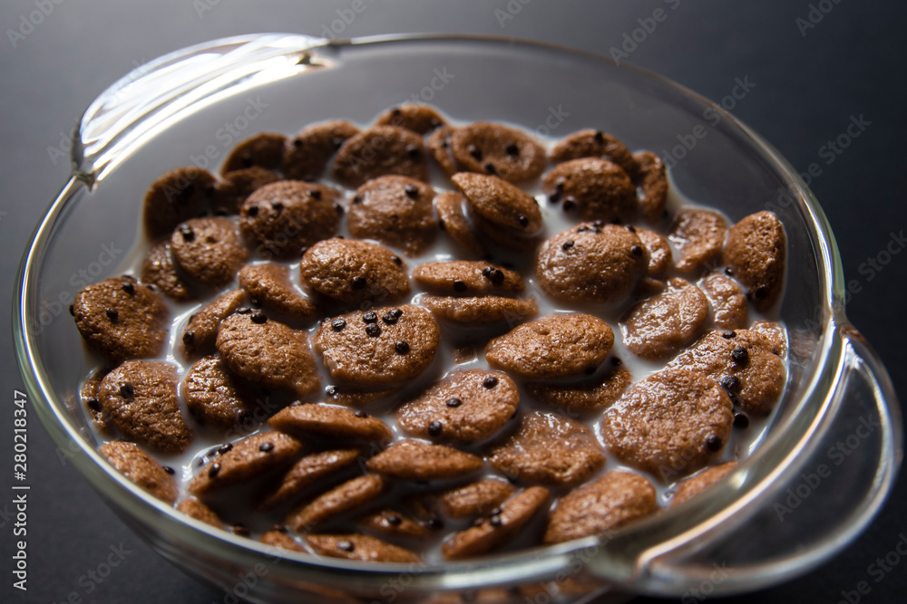 Chocolate muesli in milk on glass plate with backlight Chocolate muesli in milk on glass plate with backlight