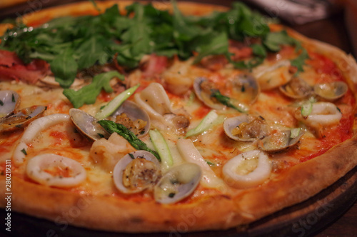 Seafood pizza with shrimp, squid, clam and lettuce topping