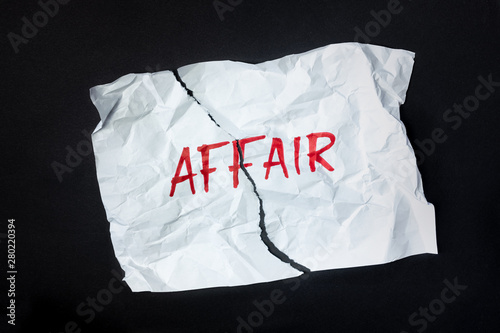 Word "affair" handwritten on crumpled paper, top view. Sign, concept of broken or failed relationship, abstract illustrative image