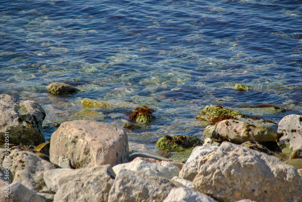 pebble beach with rocks in the water