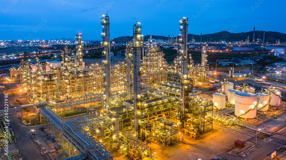 Fototapeta premium Aerial view petrochemical plant and oil refinery plant background at night, Petrochemical oil refinery factory plant at night.