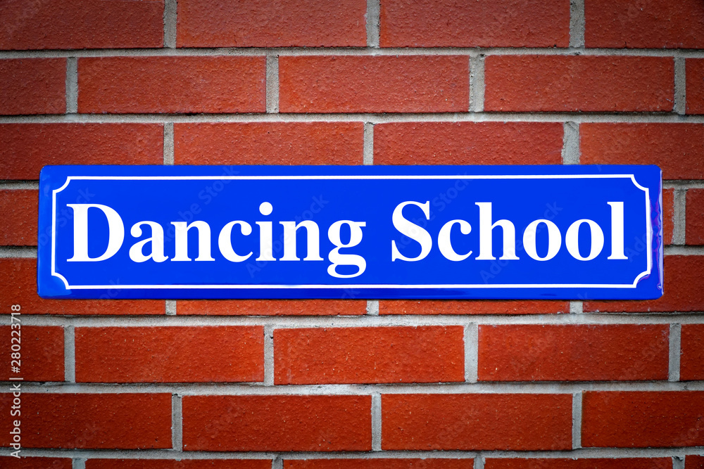 Dancing school street sign on brick wall Dancing school street sign on brick wall