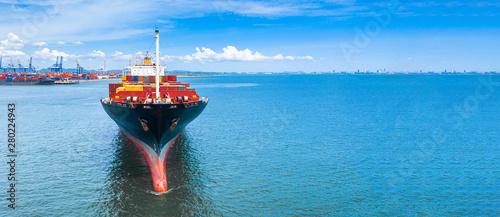 Fototapeta Naklejka Na Ścianę i Meble -  Aerial side view container ship carrying container in import export business logistic and transportation of international by container ship in the open sea, with copy space.