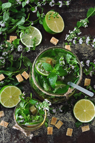 Homemade mojito drink with mint, lime and brown sugar. Healthy summer lemonade. Detox diet. Tonic drinks.
