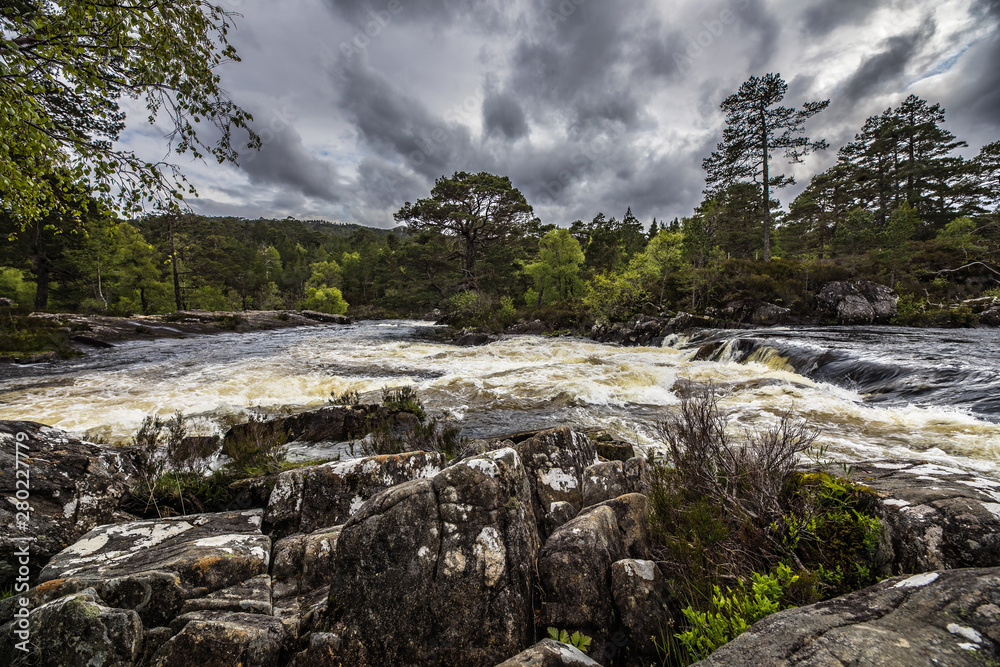 Picturesque landscape of a mountain river with traditional nature of Scotland.