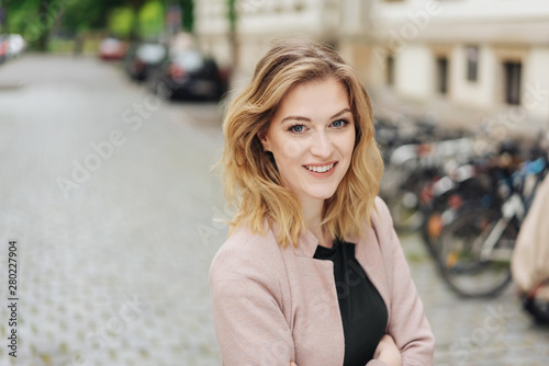 Confident stylish young woman with crossed arms © contrastwerkstatt