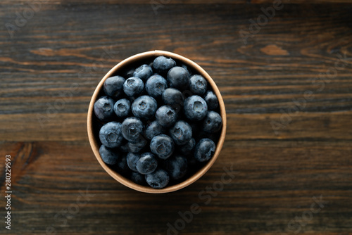 Fresh organic blueberries in a paper cup
