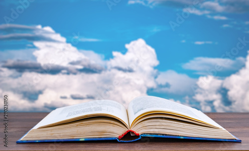 detailed book on a background of blue sky with white clouds