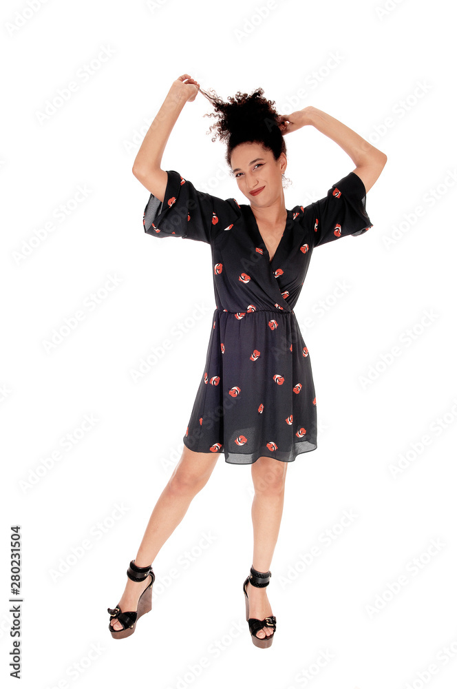 Gorgeous multi-racial woman standing pulling her hair Gorgeous multi-racial woman standing pulling her hair