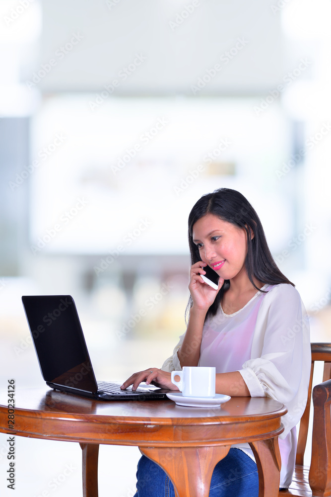 Young pretty business woman with notebook in office