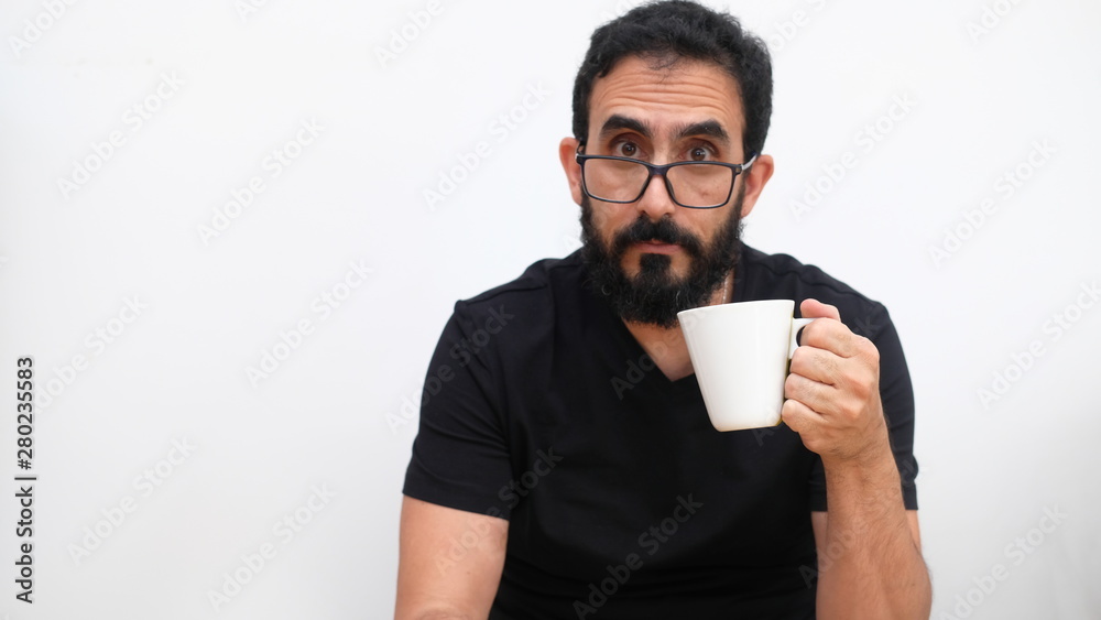 Middle age man in a white backround holding a cup of coffee Middle age man in a white backround holding a cup of coffee