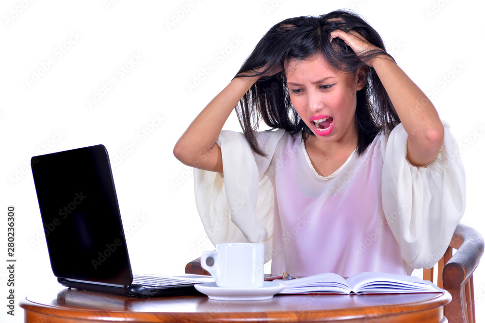 Stressed businesswoman shouting loudly at laptop