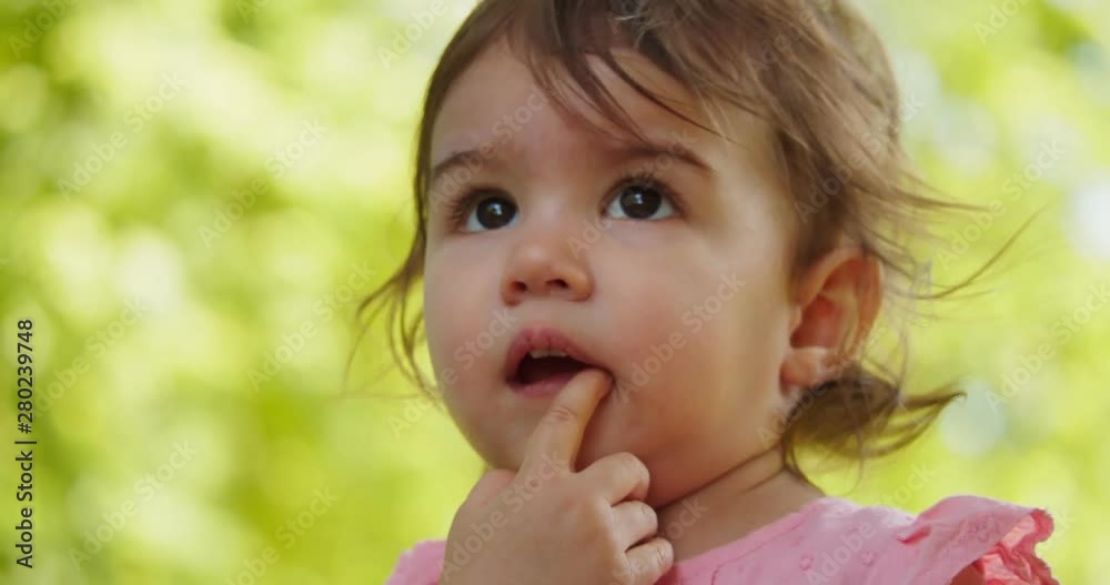 Cute baby girl exploring a park in summer. Real life, candid 4K footage. Cute baby girl exploring a park in summer. Real life, candid 4K footage.