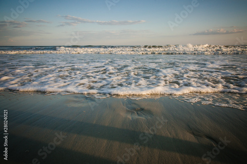 imprints in the sand from the tide