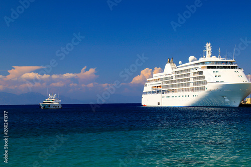 A large white cruise Liner ship stands in the tourist sea port  Rhodes  Greece. Water transport for a travel  recreation. Liner on sea or ocean  summer rest  vacation.
