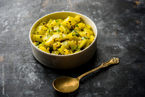 Lauki/doodhi ki sookhi Sabji also known as bottle gourd dry vegetable recipe. served in a bowl or karahi. selective focus photo