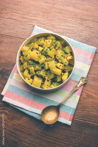 Lauki/doodhi ki sookhi Sabji also known as bottle gourd dry vegetable recipe. served in a bowl or karahi. selective focus photo