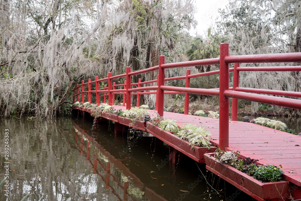 The red bridge in Magnolia plantation and garden near Charleston, South Carolina The red bridge in Magnolia plantation and garden near Charleston, South Carolina